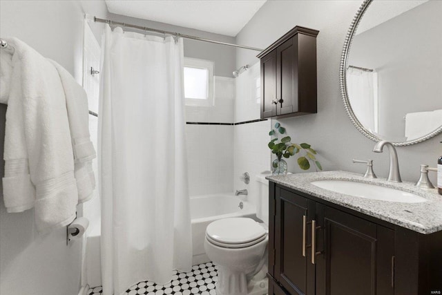 bathroom featuring vanity, shower / tub combo, and toilet