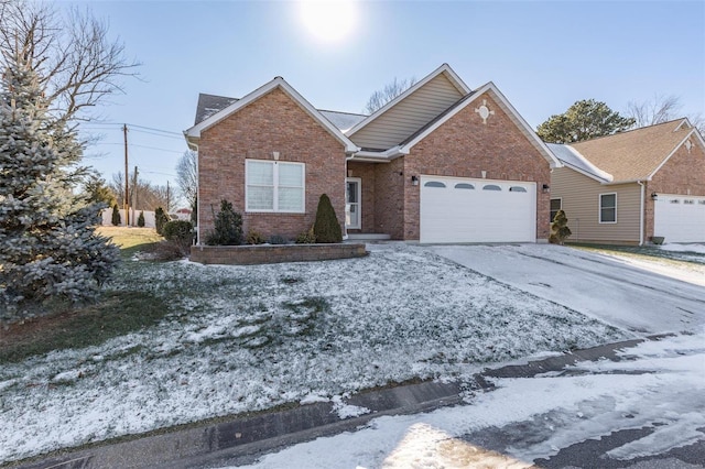 ranch-style home with driveway, an attached garage, and brick siding