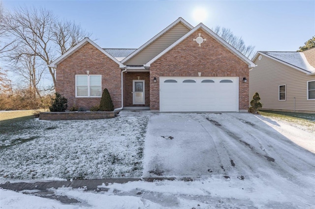 view of front of home featuring a garage, brick siding, and driveway