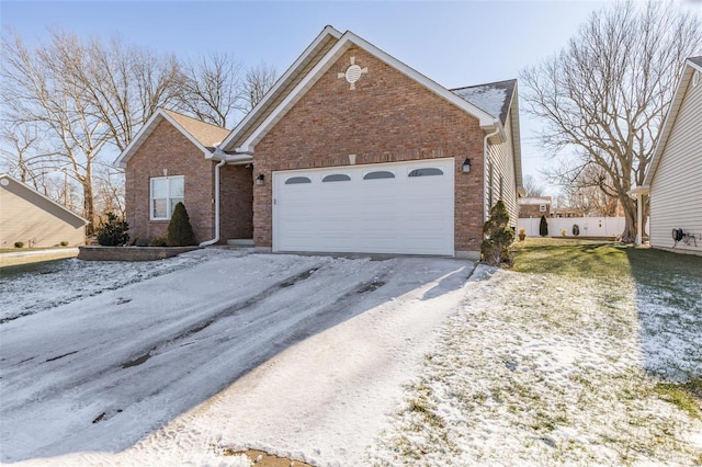 view of front of home with a garage, driveway, and brick siding