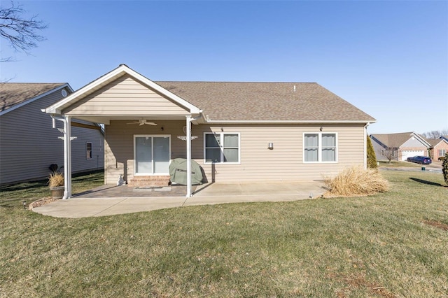 rear view of property with a patio area, a shingled roof, a ceiling fan, and a lawn