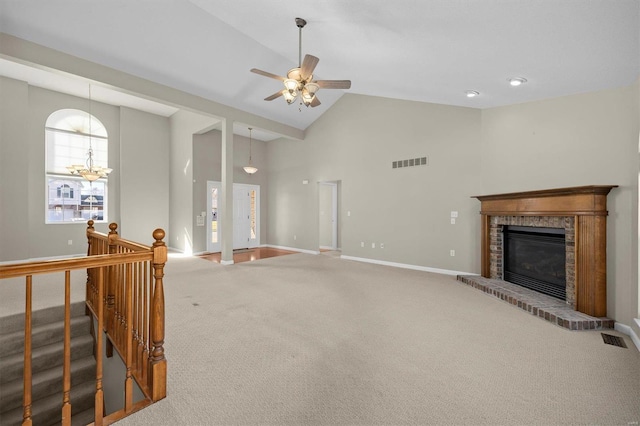 carpeted living room featuring high vaulted ceiling, baseboards, a fireplace, and visible vents