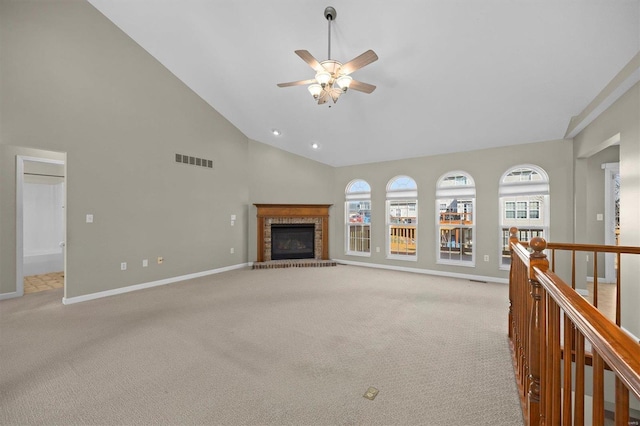 unfurnished living room featuring visible vents, a brick fireplace, light carpet, high vaulted ceiling, and baseboards