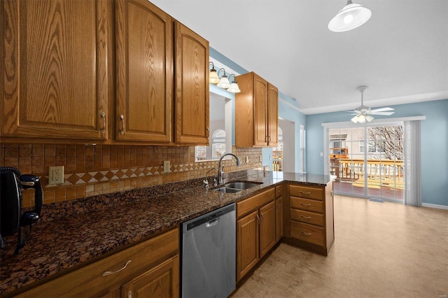 kitchen with tasteful backsplash, brown cabinets, dishwasher, and a sink