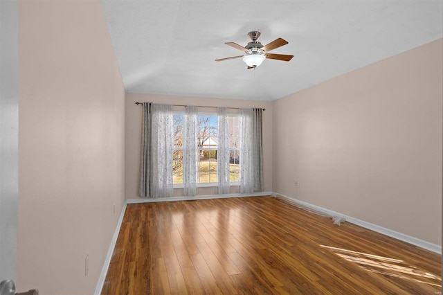 empty room with wood-type flooring, ceiling fan, and baseboards