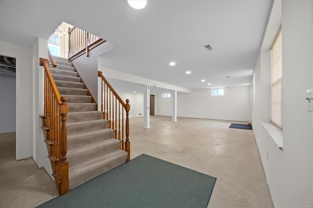 below grade area with stairs, visible vents, and recessed lighting