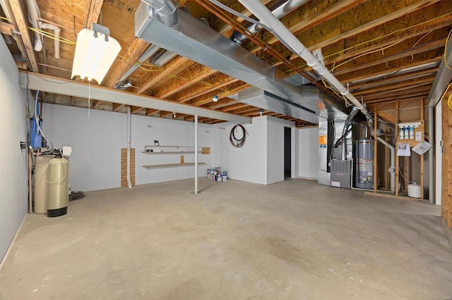 unfinished basement featuring gas water heater and heating unit