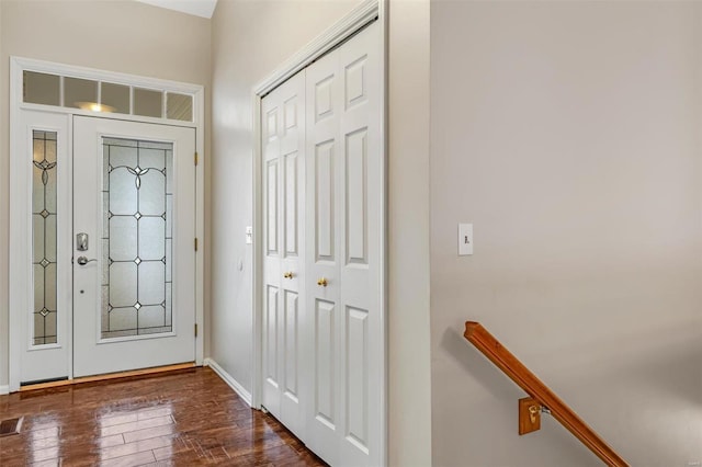 entrance foyer featuring dark wood finished floors and baseboards