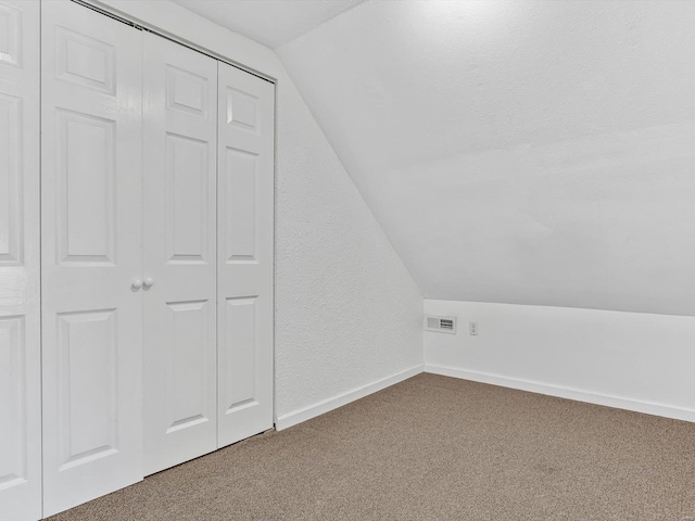 bonus room featuring carpet floors, visible vents, vaulted ceiling, and baseboards