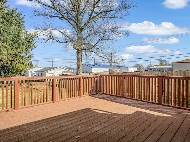 wooden terrace with a residential view and fence