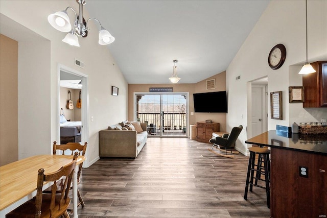 interior space featuring visible vents, high vaulted ceiling, and dark wood-style floors