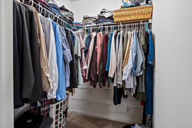 walk in closet featuring carpet flooring