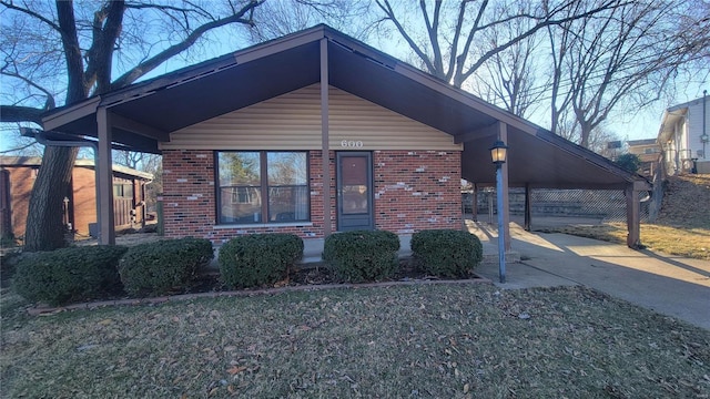 view of front of house featuring concrete driveway and brick siding