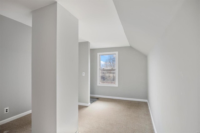 bonus room featuring lofted ceiling, carpet, and baseboards