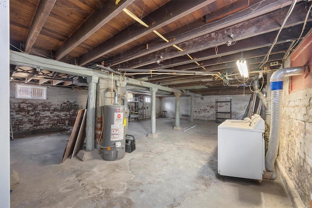 unfinished basement featuring water heater and washer / clothes dryer