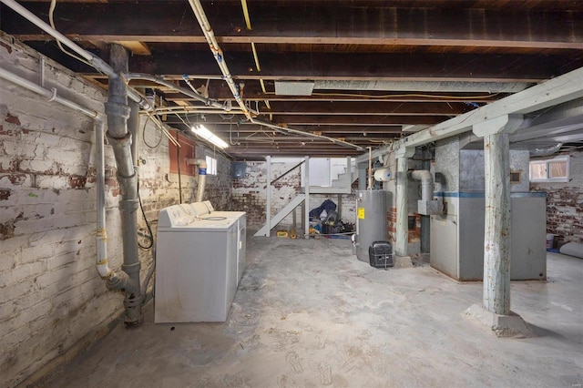 basement with water heater, independent washer and dryer, and heating unit