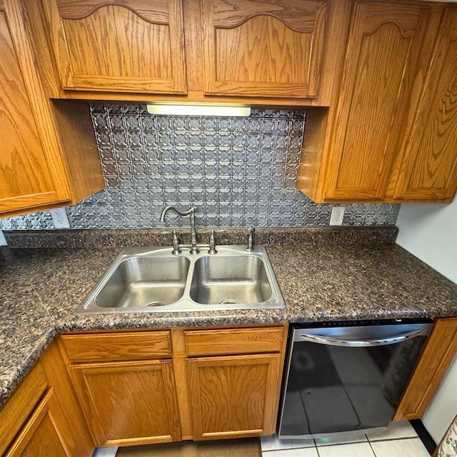 kitchen featuring dark stone counters, a sink, brown cabinets, dishwasher, and tasteful backsplash