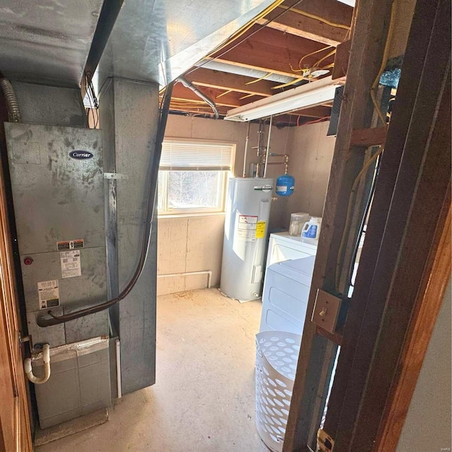 utility room featuring water heater, separate washer and dryer, and heating unit