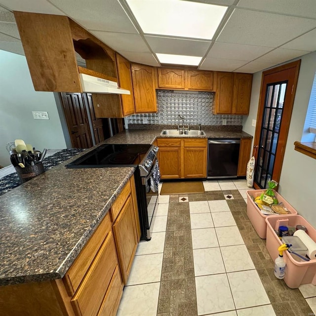 kitchen with dishwashing machine, range with electric stovetop, a sink, backsplash, and brown cabinets