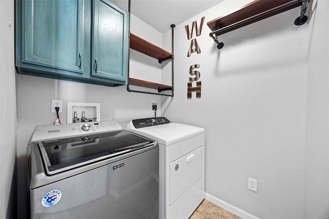 laundry room featuring light tile patterned flooring, cabinet space, baseboards, and separate washer and dryer