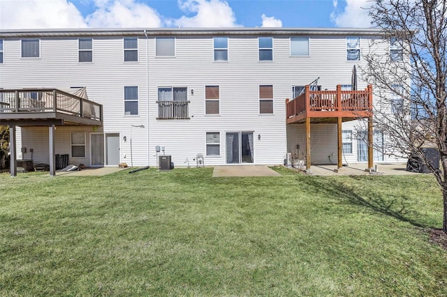 back of house featuring a yard and central AC unit