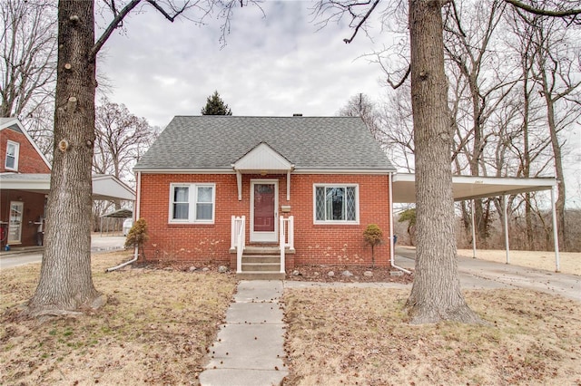 bungalow-style home featuring brick siding, an attached carport, concrete driveway, and roof with shingles