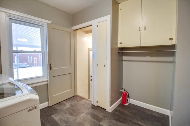 laundry room with washer / dryer, cabinet space, and baseboards