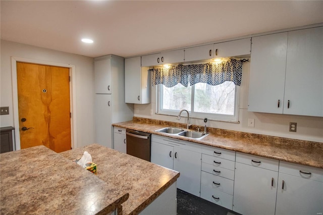 kitchen featuring stainless steel dishwasher, a sink, and recessed lighting