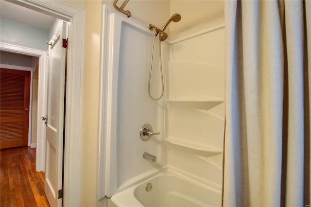 bathroom featuring shower / bathtub combination and wood finished floors