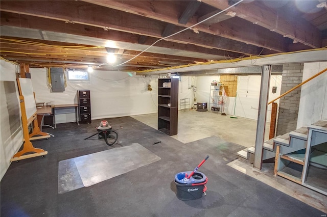 basement featuring electric panel and stairs