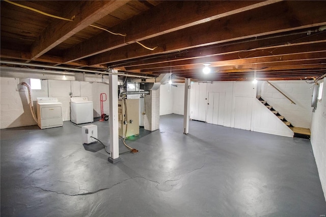 basement featuring stairway and washing machine and clothes dryer