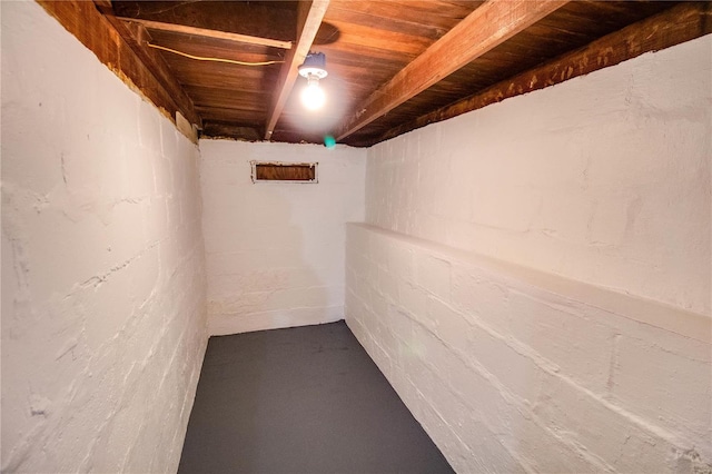 unfinished basement featuring concrete block wall