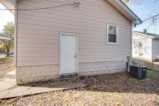 rear view of house featuring cooling unit