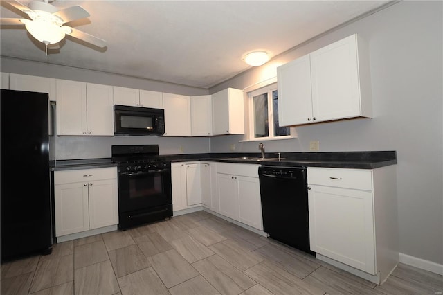 kitchen with dark countertops, a ceiling fan, white cabinetry, a sink, and black appliances