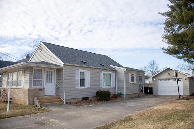 view of front of property with entry steps, a shingled roof, concrete driveway, a detached garage, and an outdoor structure