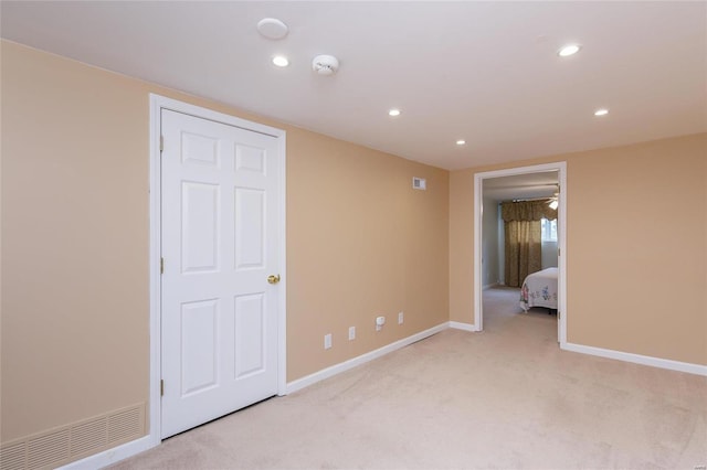 empty room with light carpet, visible vents, baseboards, and recessed lighting