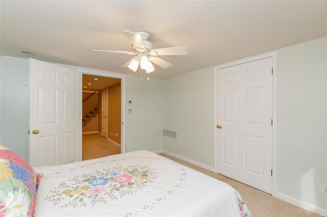 bedroom with baseboards, light carpet, visible vents, and a ceiling fan