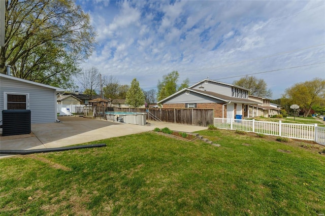 view of yard with a fenced in pool, central air condition unit, a patio, and fence