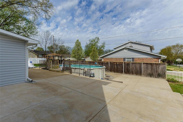 view of patio / terrace with fence and a fenced in pool