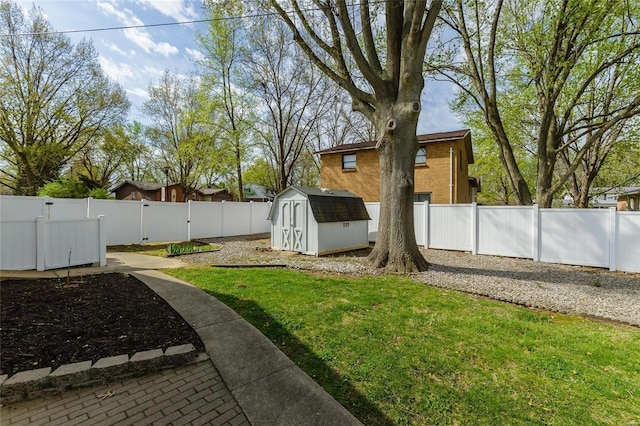 view of yard featuring a fenced backyard, a gate, a storage unit, and an outdoor structure