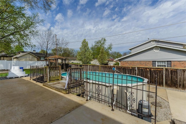 view of swimming pool featuring a patio area, fence, and a fenced in pool