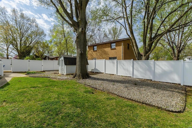 view of yard featuring a fenced backyard, a gate, a shed, and an outdoor structure