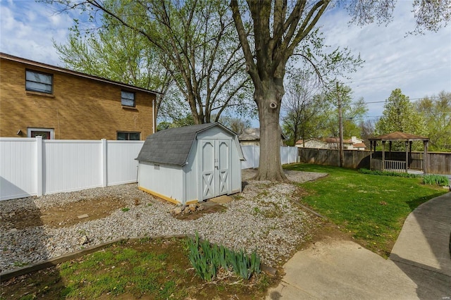 view of yard featuring a shed, an outdoor structure, and a fenced backyard