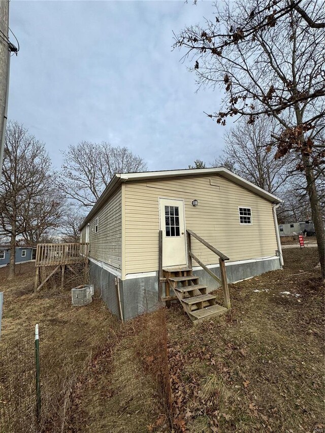 back of house featuring entry steps and central AC