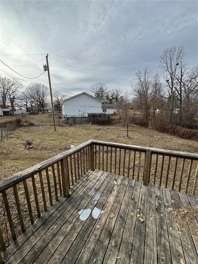 wooden deck featuring a yard