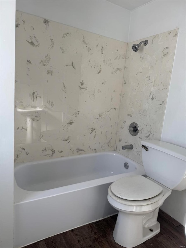 bathroom with shower / bathing tub combination, toilet, and wood finished floors