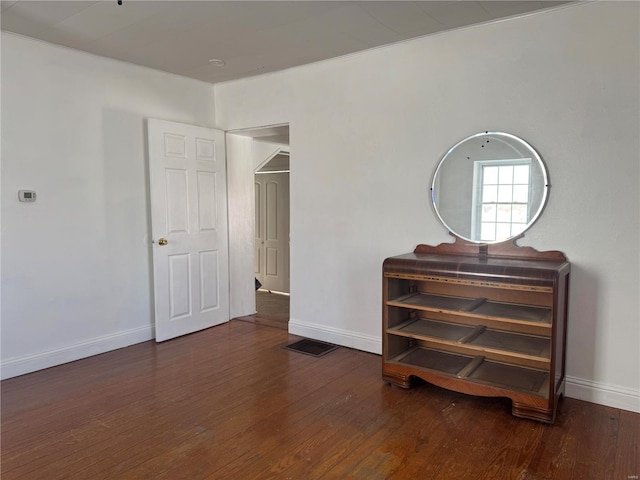 bedroom with dark wood-style floors and baseboards