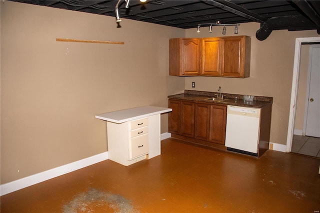 kitchen featuring finished concrete flooring, baseboards, dishwasher, brown cabinets, and a sink