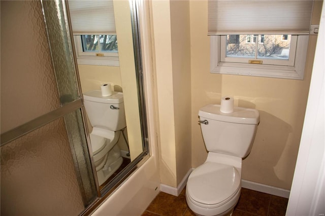 bathroom with tile patterned flooring, toilet, and baseboards