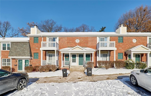 multi unit property with brick siding and a chimney